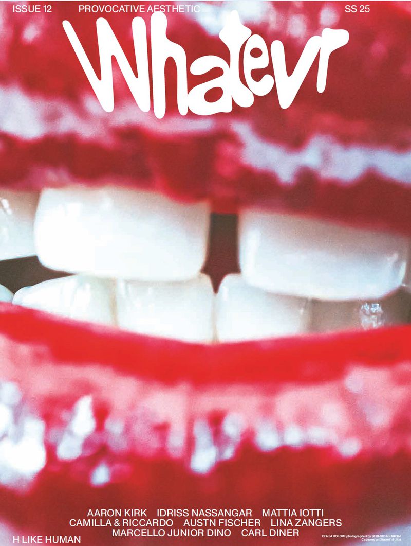 Close-up of a magazine cover featuring a mouth with white teeth and red lips, with the title 'Whatevr' and a list of names.