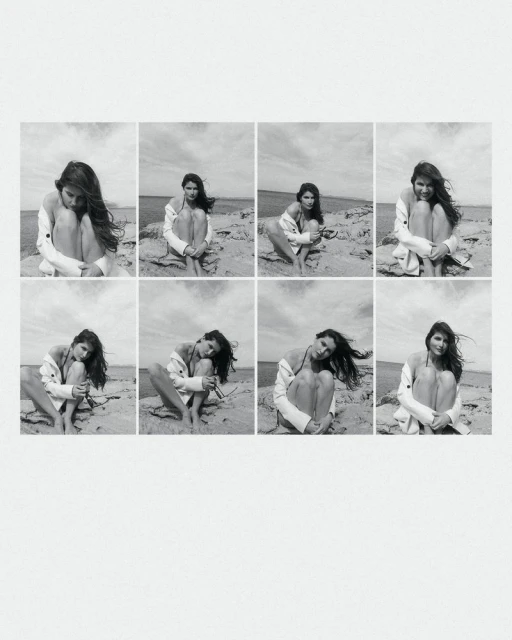 Black and white grid of a woman in a white jacket sitting on a sandy beach with rocks, with the sea and sky visible in the background.