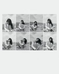 Monochrome contact sheet of model Laetitia Casta seated on a rocky coast wearing a white jacket for Madame Figaro.