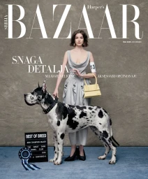 Joanna Krneta in a draped grey dress and yellow handbag standing beside a harlequin Great Dane for Harper's Bazaar Serbia cover.