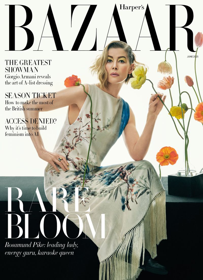 Rosamund Pike on the cover of Harper's Bazaar magazine, June 2024 issue, wears a floral dress, kneeling with flowers, against a bright background.