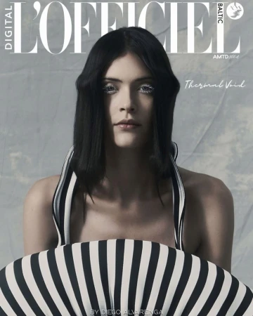 Model Thais Oliveira wearing a black and white striped sculptural top with embellished eye makeup on a digital magazine cover.