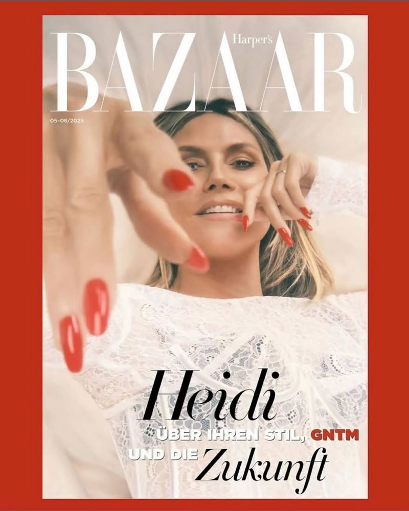 Heidi Klum covers Harper's Bazaar magazine with red nails. Close-up shot of the model wearing a white lace top and makeup.