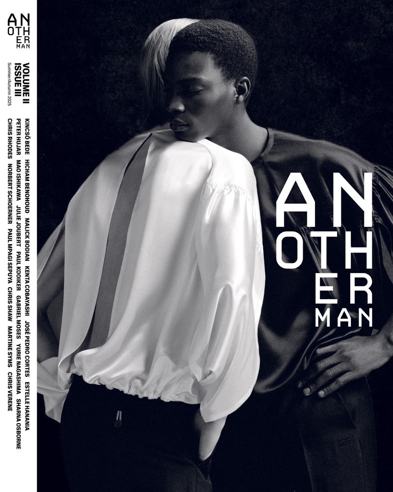 Fashion magazine cover featuring two models in satin shirts, with 'Another Man' text, shot in black and white with dramatic lighting.