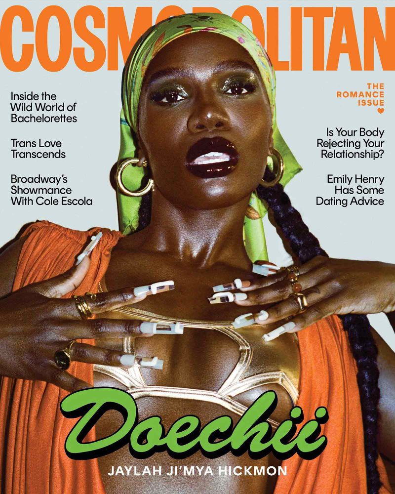 Cosmopolitan cover featuring a Black woman with green headscarf, large earrings, nail art, and gold body paint against a colorful backdrop.