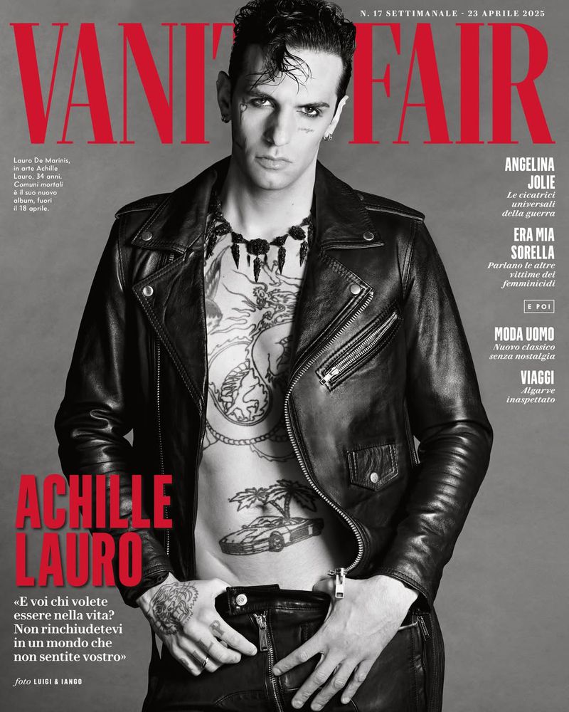 Vanity Fair cover featuring Achille Lauro in a black leather jacket, showcasing tattoos, jewelry, and makeup, against a magazine-text background.
