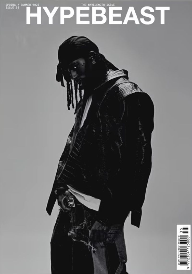 Hypebeast magazine cover in black and white featuring a person with dreadlocks in a jacket and jeans on a grey background.