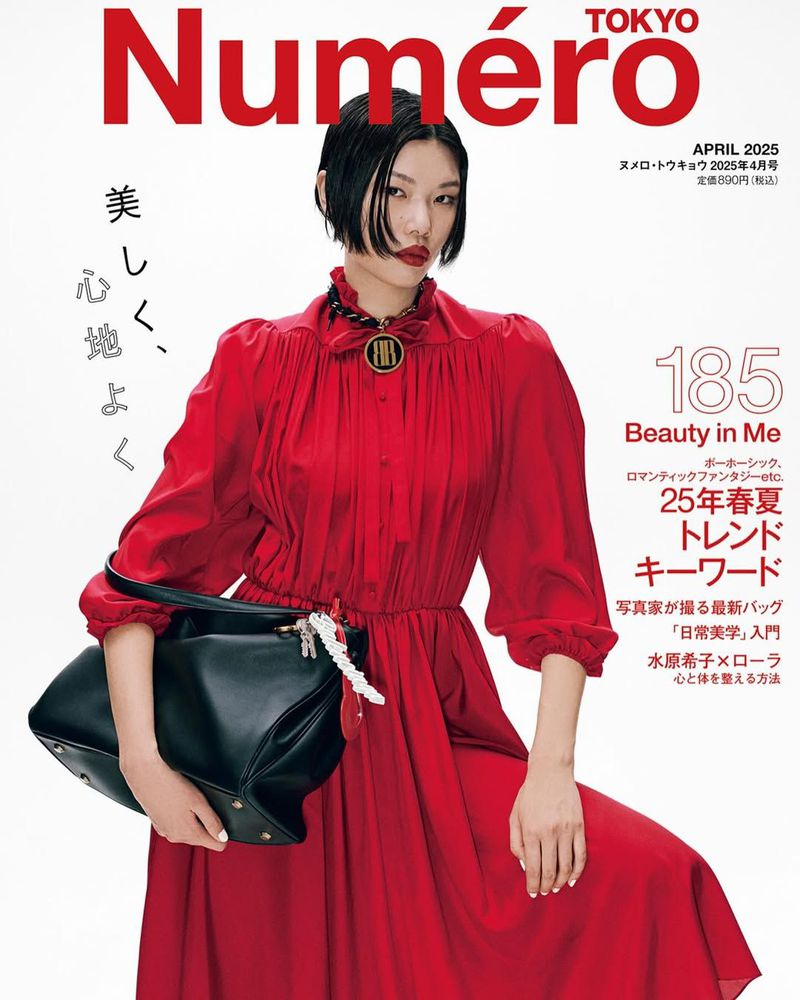 Fashion magazine cover featuring a woman in a red dress holding a black purse with bold typography and Japanese text accents. Beauty editorial.