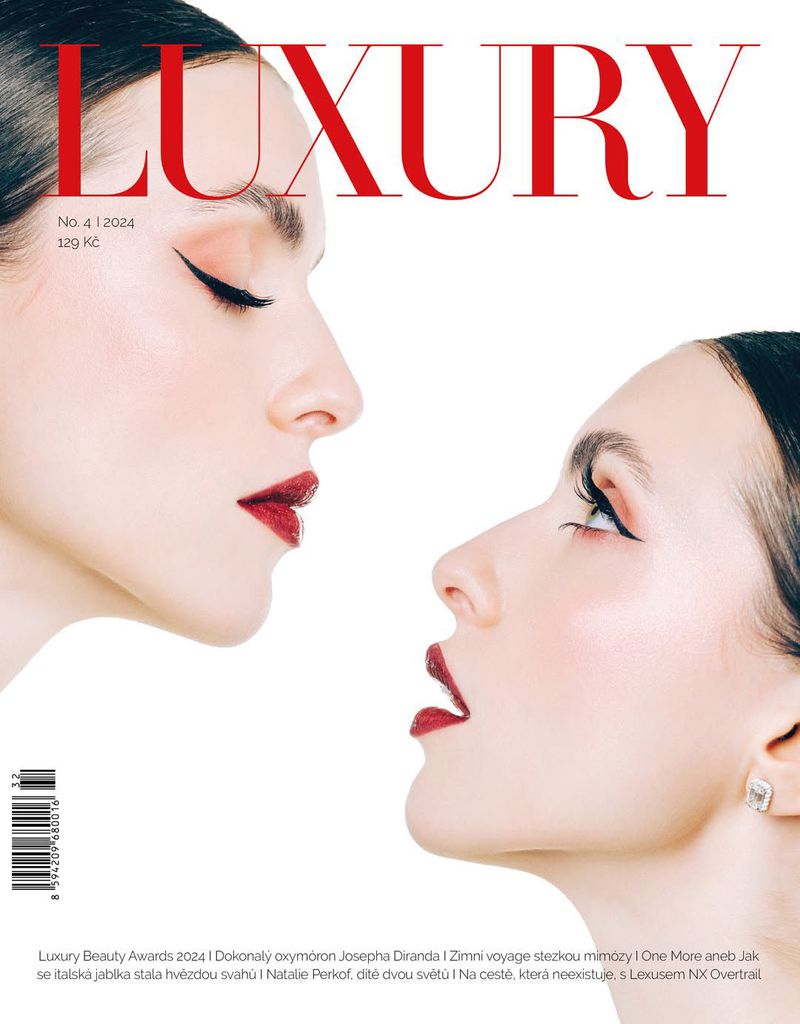 Two women's profiles face each other on a luxury magazine cover with red lipstick and sleek black eyeliner against a white background.