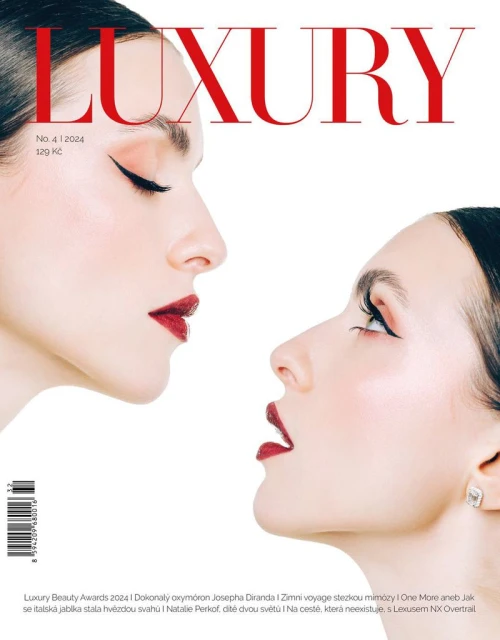 Two women's profiles face each other on a luxury magazine cover with red lipstick and sleek black eyeliner against a white background.