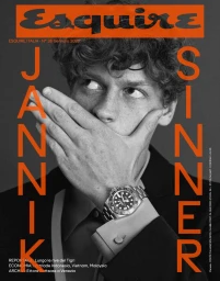 Jannik Sinner covering his mouth with his hand wearing a luxury watch on the black and white cover of Esquire Italia.