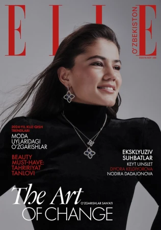 Diyora Keldiyorova smiling in a black turtleneck and diamond flower jewelry on the cover of Elle Uzbekistan.
