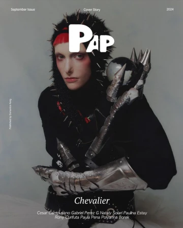 Magazine cover featuring a person in a black spiked hood and medieval gauntlets holding a sphere, with 'Chevalier' text overlay.