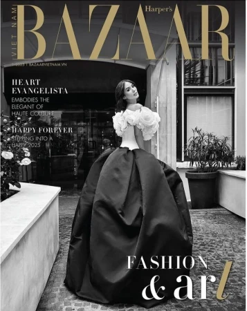 Bazaar fashion magazine cover featuring a woman in a couture gown with floral accents, set against an architectural backdrop.