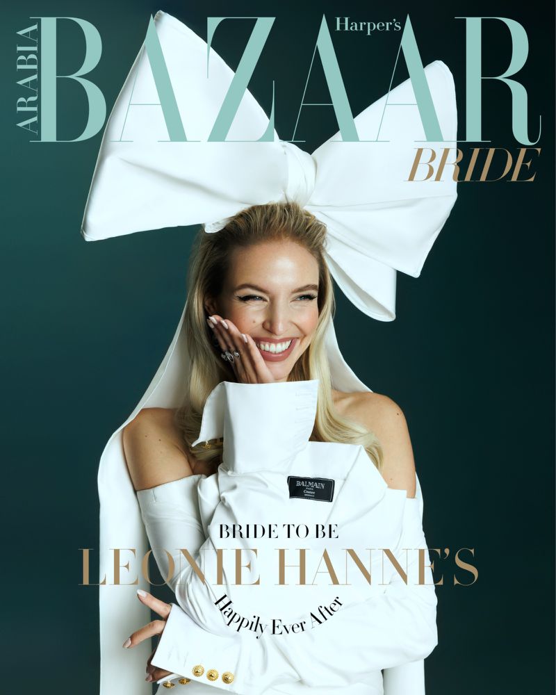Harper's Bazaar Arabia Bride cover featuring a blonde woman in a white, off-the-shoulder dress, topped with a large bow and gold accents.