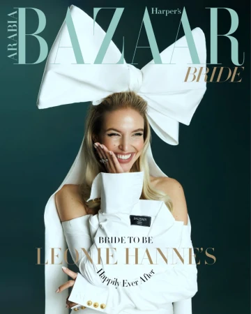Harper's Bazaar Arabia Bride cover featuring a blonde woman in a white, off-the-shoulder dress, topped with a large bow and gold accents.