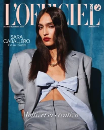 Sara Caballero on L'Officiel Chile magazine cover wearing grey suit and light blue bow
