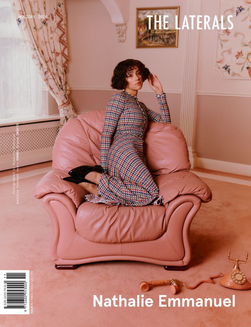 Magazine cover featuring Nathalie Emmanuel in a checked dress sitting in a pink armchair, with a retro phone and drapes.
