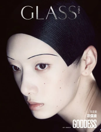 Close-up portrait of model Cici Xiang Yejing with thin arched eyebrows and dark head covering against a black background