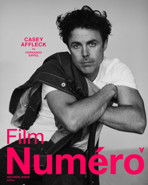 Black and white portrait of Casey Affleck wearing a white t-shirt and denim jacket, with 'Numero' magazine text overlay.