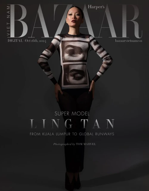 Fashion editorial shot of an Asian female model wearing a black and white patterned top, posing in front of a gray studio backdrop.