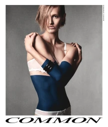Model Isabel Thuma wearing white undergarments and dark blue bodywear against a plain grey studio backdrop for Common Language.