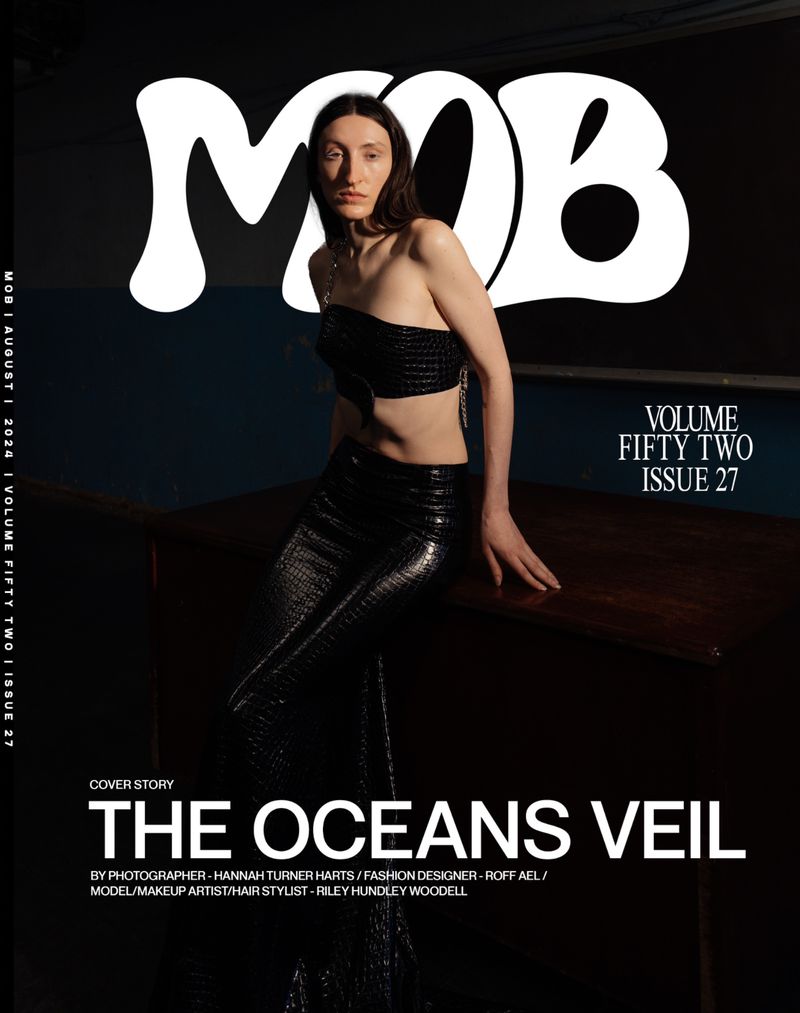 Magazine cover featuring a woman in black two-piece outfit, posing against a dark backdrop, with 'MOB' in large white font at the top.