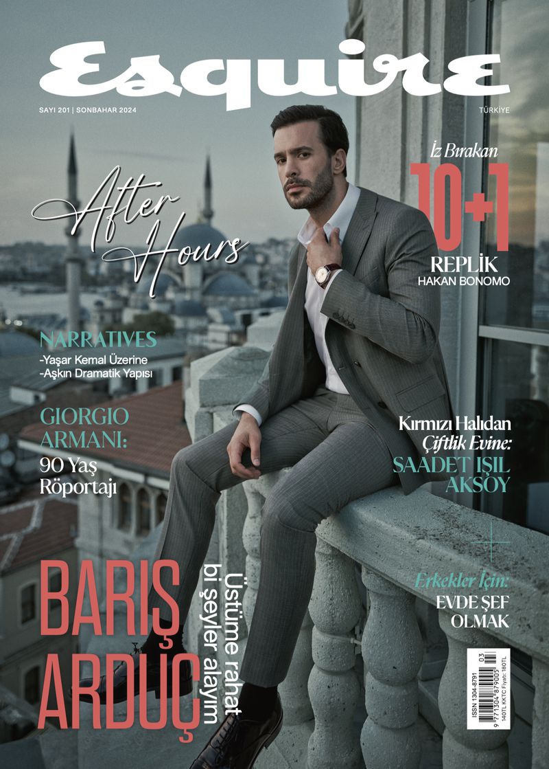 Barış Arduç in a grey suit and white shirt sitting on a balcony balustrade overlooking an Istanbul cityscape for an Esquire cover.