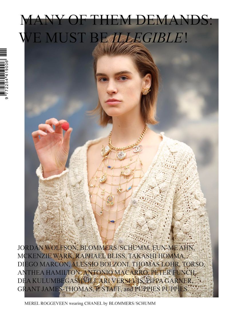 Elegant editorial shot of a young woman wearing a cream cardigan and gold jewelry, holding a single raspberry, with gray background.