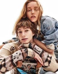 Two models posing together with a skateboard for DLMAU editorial, photographed by Steven Chee against a bright white background.