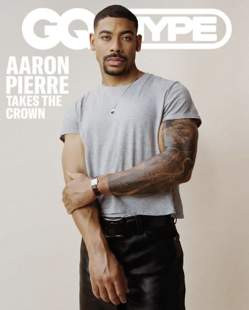 Aaron Pierre on magazine cover; he wears a gray T-shirt and leather pants, posing against a neutral backdrop, with the GQ Type logo.