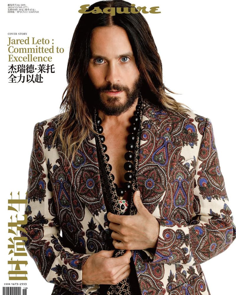 Portrait of Jared Leto on magazine cover, wearing a patterned blazer and beaded necklace, against a white background with masthead.
