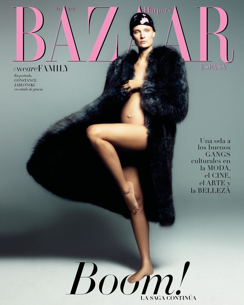Magazine cover featuring a pregnant Constance Jablonski in a dark fur coat and head covering, posing in front of a light grey background.