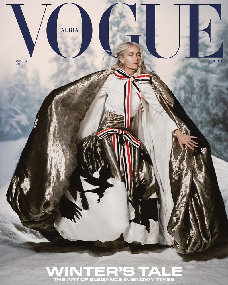 Vogue Adria cover features a model in a white and gold outfit with snowy winter scene background, creating an elegant and seasonal visual.