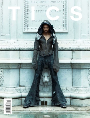 Fashion magazine cover featuring a male model wearing a dark hooded leather jacket and bell-bottom jeans, standing in front of a fountain.