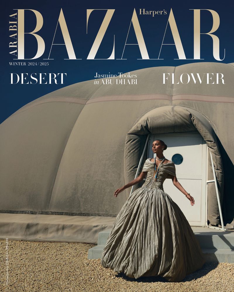 Harper's Bazaar cover featuring Jasmine Tookes in Abu Dhabi, wearing a formal gown with a tent-like structure and desert background under a blue sky.