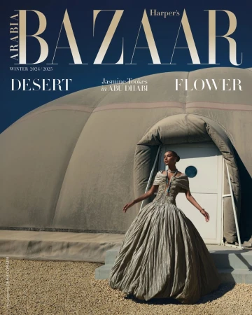 Harper's Bazaar cover featuring Jasmine Tookes in Abu Dhabi, wearing a formal gown with a tent-like structure and desert background under a blue sky.