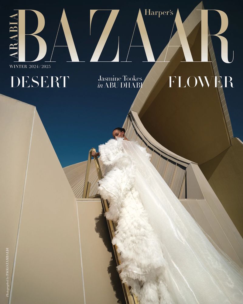 Harper's Bazaar Arabia cover featuring Jasmine Tookes in Abu Dhabi, wearing a white gown with architectural backdrop and blue sky.