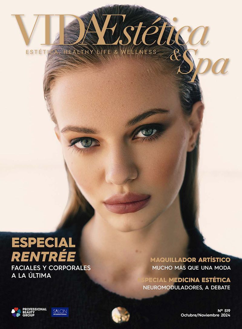 Magazine cover featuring a blonde woman with neutral makeup and a black blazer, set against a soft, light background with bold title text.