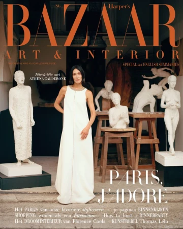 Woman in a long white dress standing amidst various white sculptures for Harpers Bazaar Arts and Interior October 2024