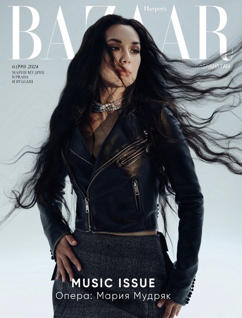 Bazaar magazine cover featuring Maria Mudryk wearing a leather jacket and jewelry, with flowing hair against a pale blue background.