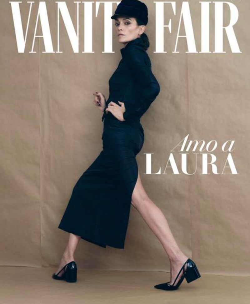 Vanity Fair cover featuring a woman in a black outfit and hat walking across a beige background, as she poses for the magazine cover.