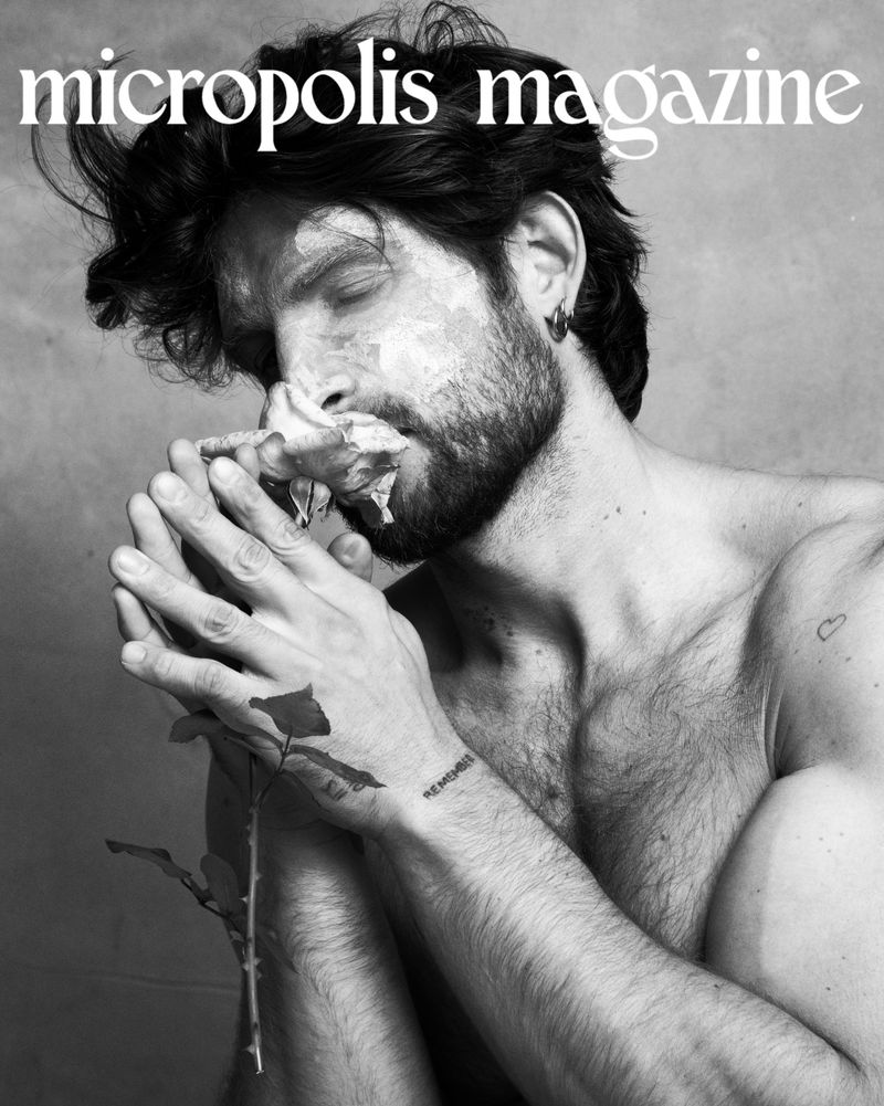 Monochrome magazine cover portrait of a man smelling a rose, photographed by Evangelos Rodoulis for micropolis magazine.