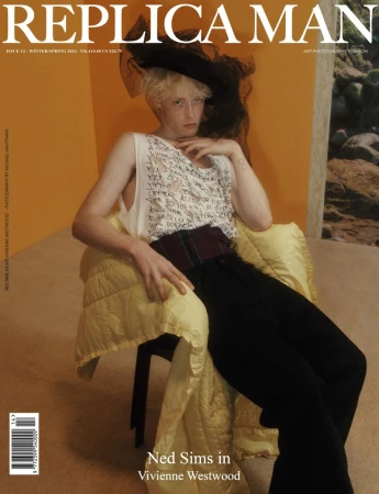 Magazine cover featuring a young male model, Ned Sims, wearing a black hat and tank top, posing in a chair with a patterned blanket.