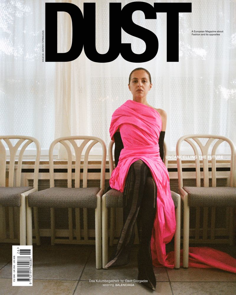 Magazine cover featuring a woman in a pink dress sitting on a chair. The title "DUST" is prominently displayed at the top.