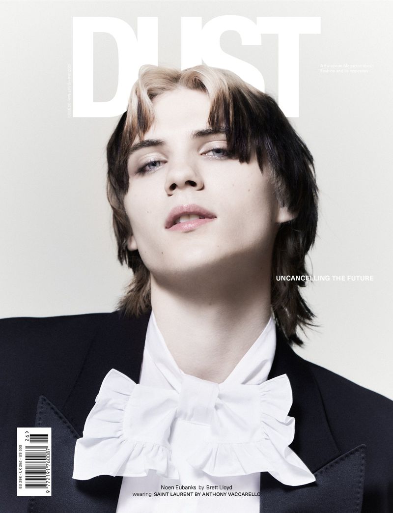 Magazine cover featuring a young adult with dyed black and blonde hair wearing a black tuxedo with a white ruffled shirt, shot indoors.
