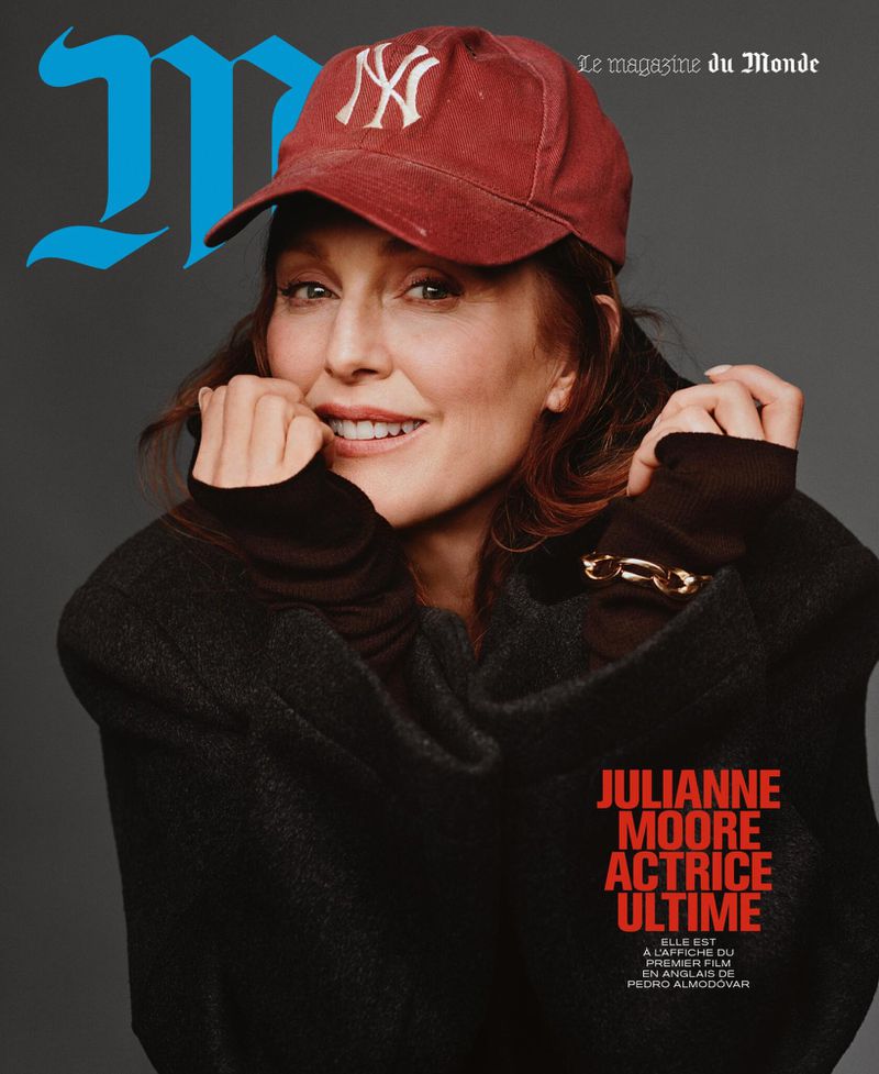 Magazine cover featuring Julianne Moore wearing a baseball cap and black sweater, smiling against a gray background. The magazine's logo is in blue.