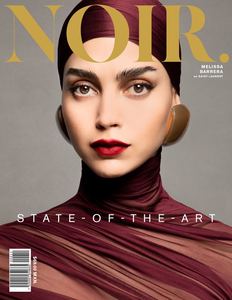 Magazine cover featuring Melissa Barrera in a high-fashion portrait, wearing a burgundy headscarf and draped top, set against a grey backdrop.