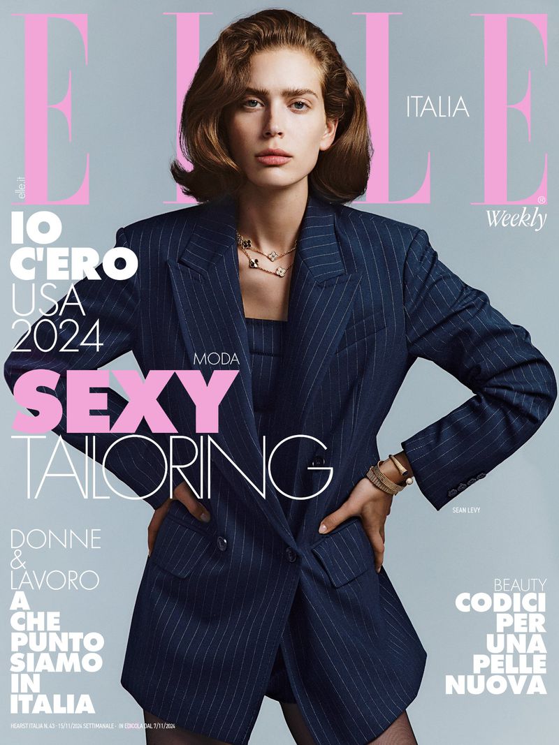 Elle Italia magazine cover featuring a female model in a pinstripe suit, posing with hands on hips. Magazine text includes 'Sexy Tailoring'.