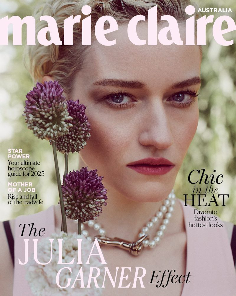 Close-up of Julia Garner on Marie Claire Australia cover, showcasing floral accents, a pearl necklace, and a pale pink dress in an outdoor setting.